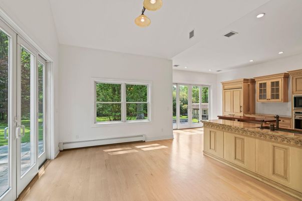 Empty room, Interior, Kitchen, Pendant Lights, Recessed Lighting, Stainless Steel Appliances, Wood Texture Flooring