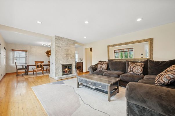 Dining room, Fireplace, Interior, Living room, Recessed Lighting, Stone Walls, Wood Texture Flooring