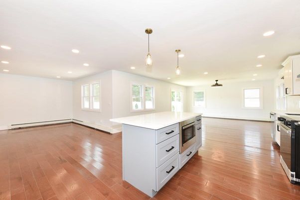 Empty room, Interior, Kitchen, Pendant Lights, Recessed Lighting, Stainless Steel Appliances, Wood Texture Flooring
