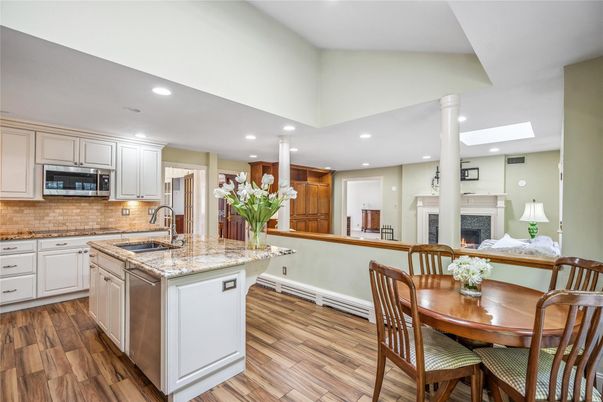 Dining room, Fireplace, Interior, Kitchen, Recessed Lighting, Stainless Steel Appliances, Wood Texture Flooring