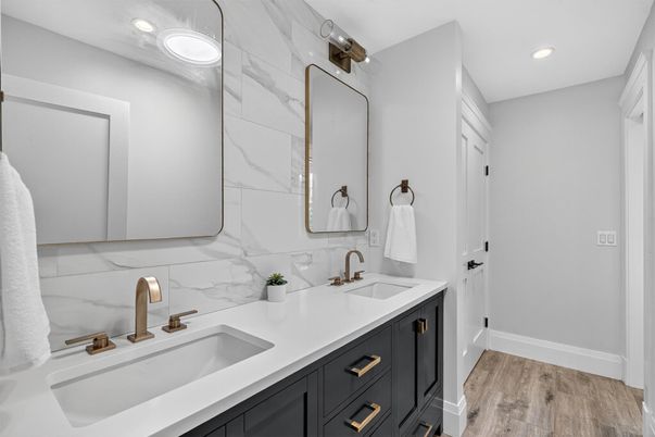 Bathroom, Dual Sink Vanities, Interior, Marble Walls, Recessed Lighting, Wood Texture Flooring