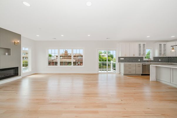 Empty room, Fireplace, Interior, Kitchen, Pendant Lights, Recessed Lighting, Stainless Steel Appliances, Wood Texture Flooring