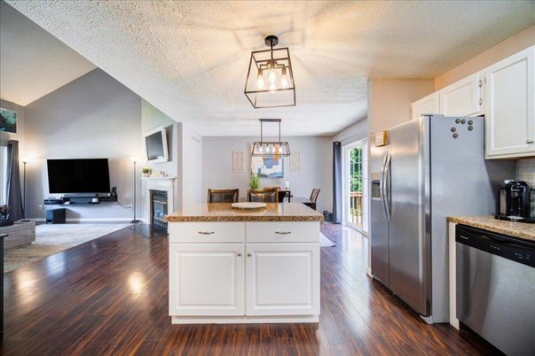 Dining room, Fireplace, Interior, Kitchen, Pendant Lights, Stainless Steel Appliances, Wood Texture Flooring