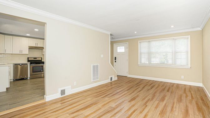 Empty room, Interior, Kitchen, Recessed Lighting, Stainless Steel Appliances, Wood Texture Flooring