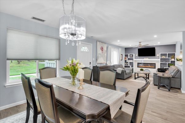 Chandelier, Dining room, Fireplace, Interior, Living room, Pendant Lights, Recessed Lighting, Wood Texture Flooring