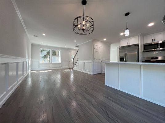 Chandelier, Empty room, Interior, Kitchen, Pendant Lights, Recessed Lighting, Stainless Steel Appliances, Wood Texture Flooring