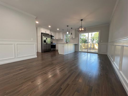 Empty room, Interior, Kitchen, Pendant Lights, Recessed Lighting, Stainless Steel Appliances, Wood Texture Flooring