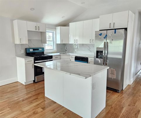 Interior, Kitchen, Marble Walls, Recessed Lighting, Stainless Steel Appliances, Wood Texture Flooring