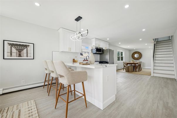 Dining room, Interior, Kitchen, Pendant Lights, Recessed Lighting, Stainless Steel Appliances, Wood Texture Flooring