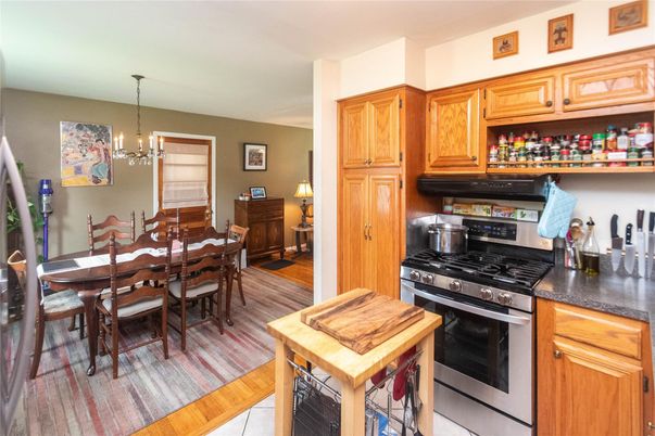 Chandelier, Dining room, Interior, Kitchen, Pendant Lights, Stainless Steel Appliances, Wood Texture Flooring