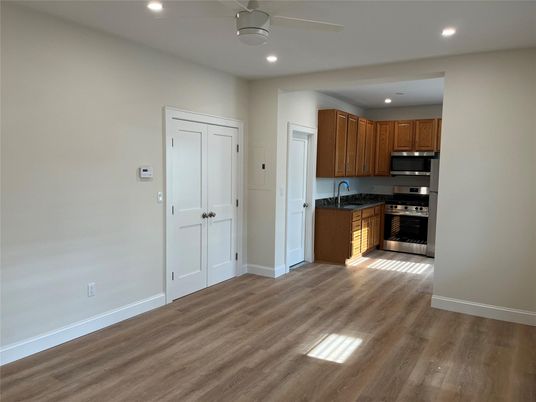 Empty room, Interior, Kitchen, Recessed Lighting, Stainless Steel Appliances, Wood Texture Flooring