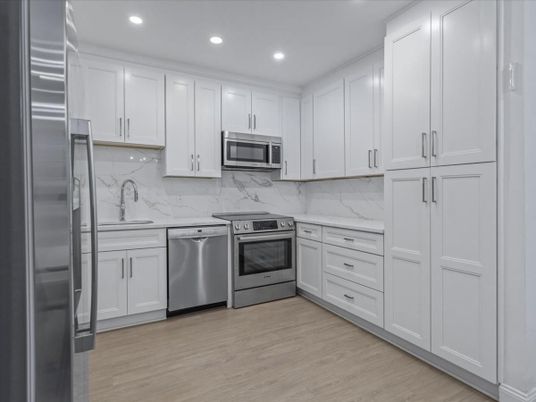 Interior, Kitchen, Marble Walls, Recessed Lighting, Stainless Steel Appliances, Wood Texture Flooring