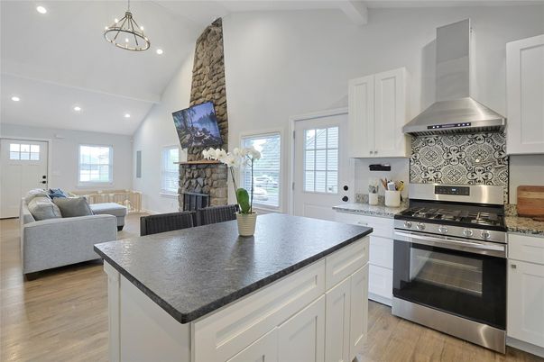 Fireplace, Interior, Kitchen, Living room, Pendant Lights, Recessed Lighting, Stainless Steel Appliances, Wood Texture Flooring