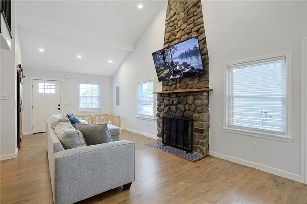 Fireplace, Interior, Living room, Recessed Lighting, Stone Walls, Wood Texture Flooring