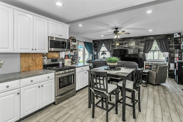Dining room, Interior, Kitchen, Living room, Recessed Lighting, Stainless Steel Appliances, Wood Texture Flooring