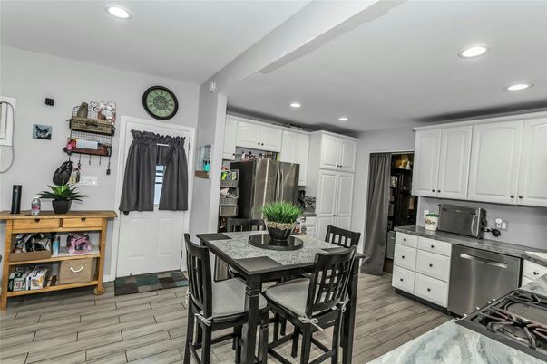 Dining room, Interior, Kitchen, Recessed Lighting, Stainless Steel Appliances, Wood Texture Flooring