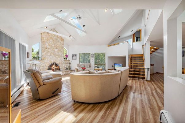 Fireplace, Interior, Living room, Recessed Lighting, Stone Walls, Wood Texture Flooring