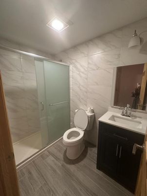 Bathroom, Glass Shower, Interior, Marble Walls, Wood Texture Flooring