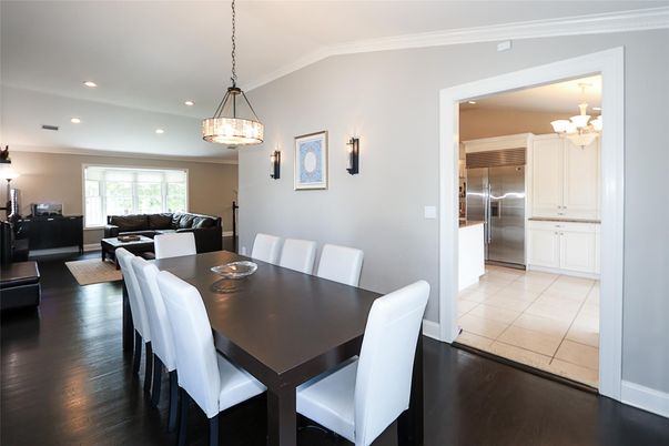 Chandelier, Dining room, Interior, Kitchen, Living room, Pendant Lights, Recessed Lighting, Stainless Steel Appliances, Wood Texture Flooring