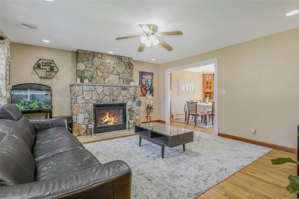Dining room, Fireplace, Interior, Living room, Recessed Lighting, Stone Walls, Wood Texture Flooring