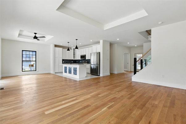 Empty room, Interior, Kitchen, Pendant Lights, Recessed Lighting, Stainless Steel Appliances, Wood Texture Flooring