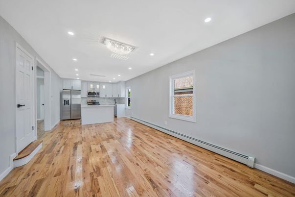 Empty room, Interior, Kitchen, Recessed Lighting, Stainless Steel Appliances, Wood Texture Flooring