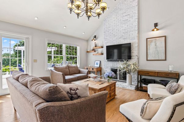 Chandelier, Fireplace, Interior, Living room, Recessed Lighting, Stone Walls, Wood Texture Flooring