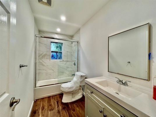 Bathroom, Glass Shower, Interior, Marble Walls, Recessed Lighting, Wood Texture Flooring
