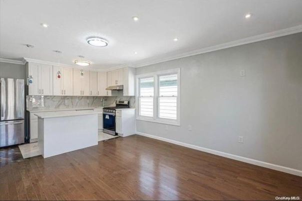 Interior, Kitchen, Marble Walls, Recessed Lighting, Stainless Steel Appliances, Wood Texture Flooring