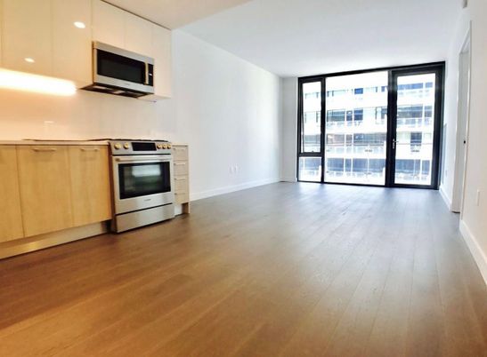 Empty room, Interior, Kitchen, Recessed Lighting, Stainless Steel Appliances, Wood Texture Flooring