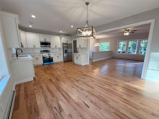 Empty room, Interior, Kitchen, Pendant Lights, Recessed Lighting, Stainless Steel Appliances, Wood Texture Flooring