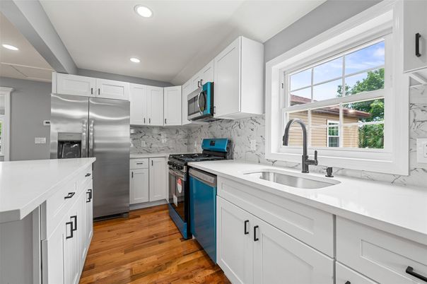 Interior, Kitchen, Marble Walls, Recessed Lighting, Stainless Steel Appliances, Wood Texture Flooring
