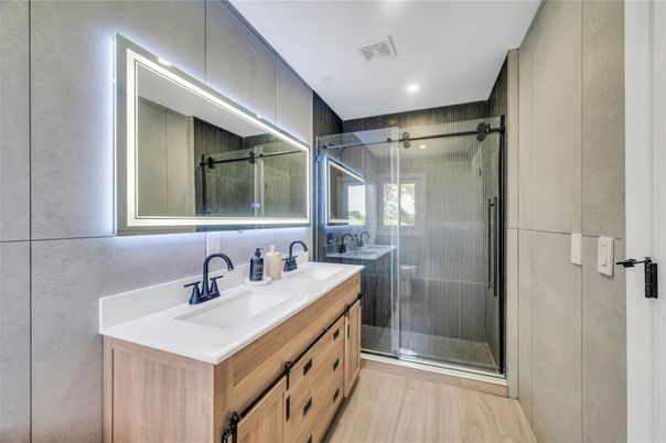 Bathroom, Dual Sink Vanities, Glass Shower, Interior, Recessed Lighting, Wood Texture Flooring