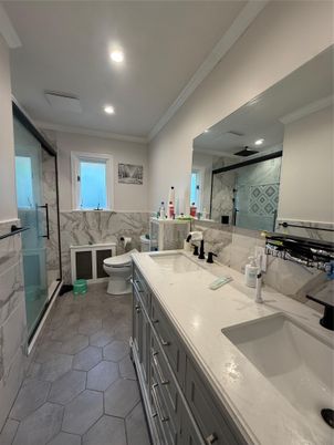 Bathroom, Dual Sink Vanities, Glass Shower, Interior, Marble Walls, Recessed Lighting