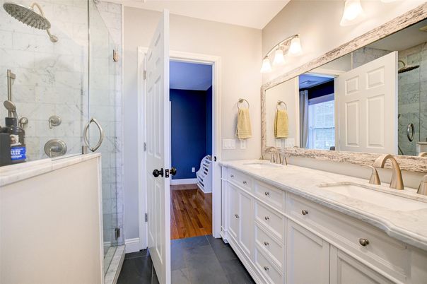 Bathroom, Dual Sink Vanities, Glass Shower, Interior, Marble Walls, Wood Texture Flooring