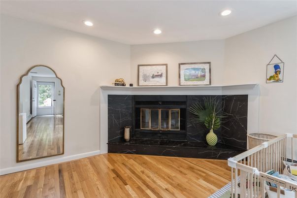 Fireplace, Interior, Marble Walls, Recessed Lighting, Wood Texture Flooring