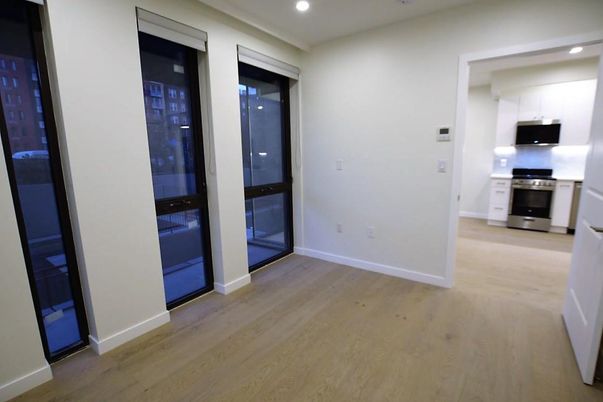 Empty room, Interior, Kitchen, Recessed Lighting, Stainless Steel Appliances, Wood Texture Flooring
