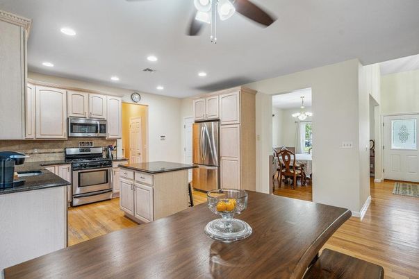 Chandelier, Dining room, Interior, Kitchen, Recessed Lighting, Stainless Steel Appliances, Wood Texture Flooring