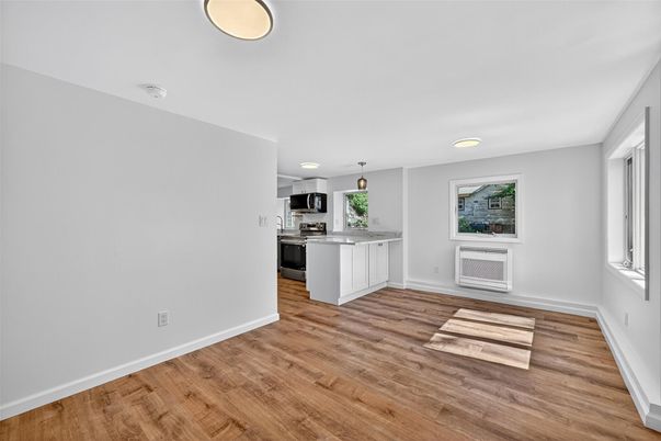 Empty room, Interior, Kitchen, Pendant Lights, Recessed Lighting, Stainless Steel Appliances, Wood Texture Flooring