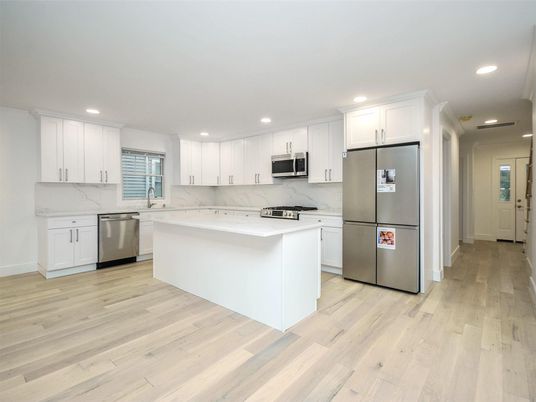 Interior, Kitchen, Marble Walls, Recessed Lighting, Stainless Steel Appliances, Wood Texture Flooring