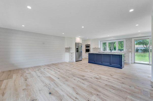 Empty room, Interior, Kitchen, Recessed Lighting, Stainless Steel Appliances, Wood Texture Flooring