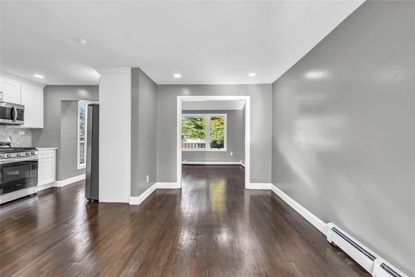 Empty room, Interior, Kitchen, Recessed Lighting, Stainless Steel Appliances, Wood Texture Flooring