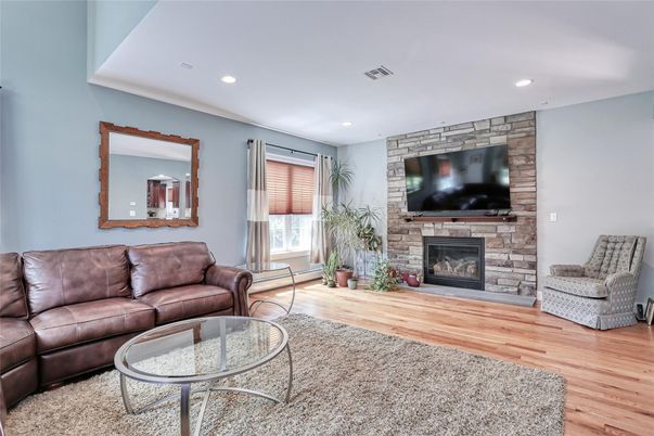 Fireplace, Interior, Living room, Recessed Lighting, Stone Walls, Wood Texture Flooring