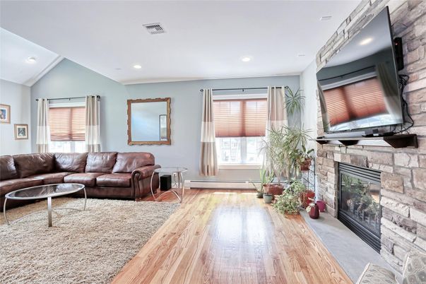 Fireplace, Interior, Living room, Recessed Lighting, Stone Walls, Wood Texture Flooring