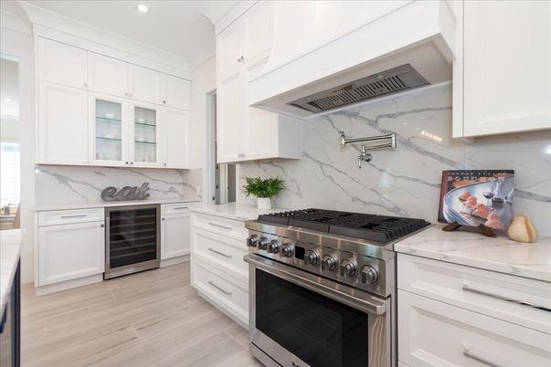 Interior, Kitchen, Marble Walls, Recessed Lighting, Stainless Steel Appliances, Wood Texture Flooring