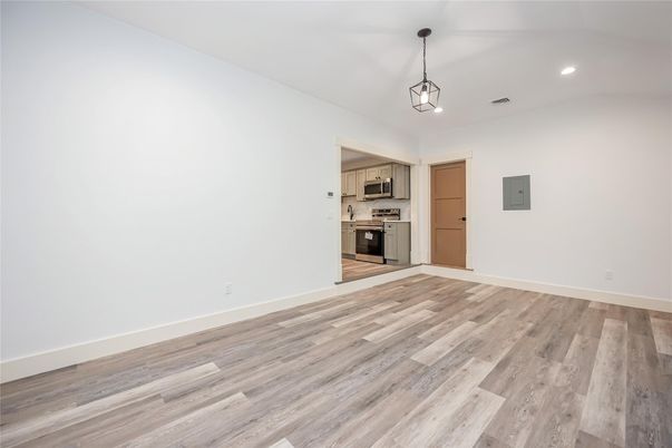 Empty room, Interior, Kitchen, Pendant Lights, Recessed Lighting, Stainless Steel Appliances, Wood Texture Flooring