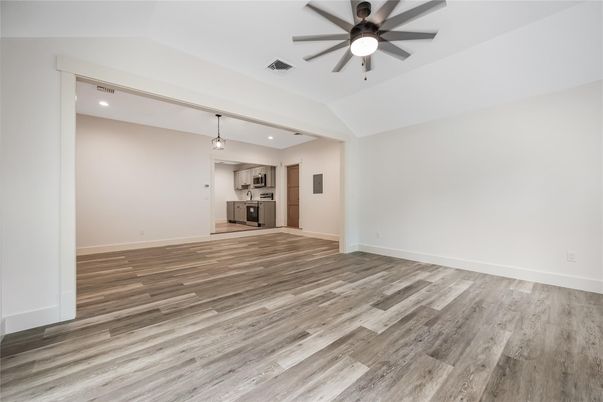 Empty room, Interior, Kitchen, Recessed Lighting, Stainless Steel Appliances, Wood Texture Flooring