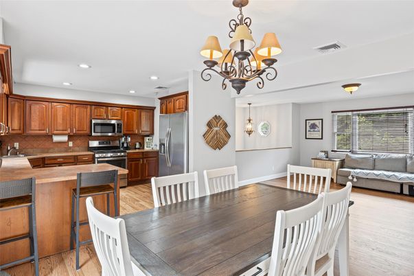 Chandelier, Dining room, Interior, Kitchen, Living room, Recessed Lighting, Stainless Steel Appliances, Wood Texture Flooring
