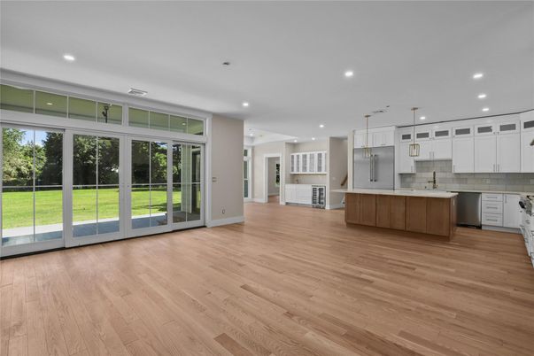 Empty room, Interior, Kitchen, Pendant Lights, Recessed Lighting, Stainless Steel Appliances, Wood Texture Flooring