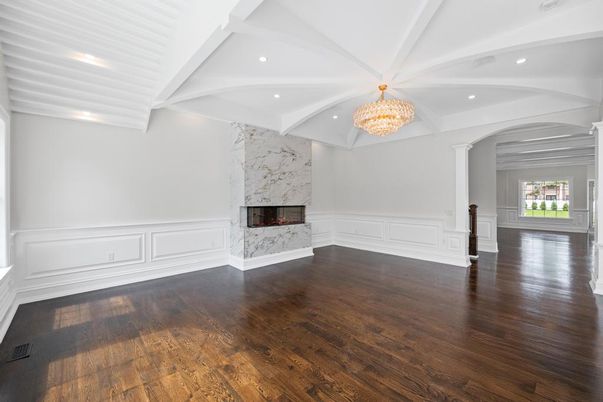 Chandelier, Empty room, Fireplace, Interior, Marble Walls, Recessed Lighting, Wood Texture Flooring